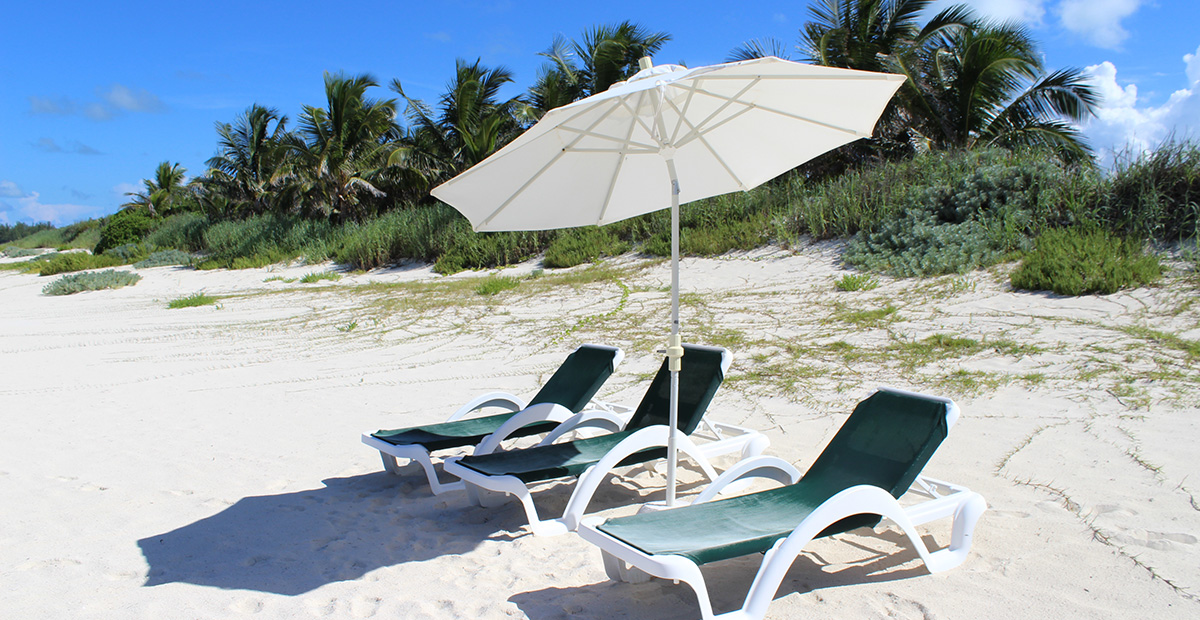 Private lounge chairs on the beach of Orchid Bay